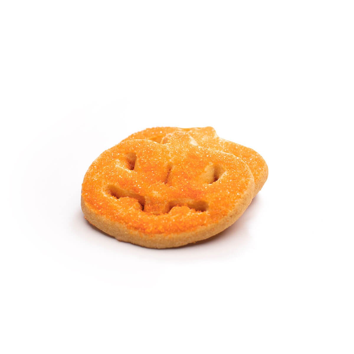 A buttery cookie shaped like a pumpkin face sprinkled with orange crystal sugar. 